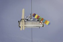 Skier And Snowboarder Riding A Chairlift In The Alps.