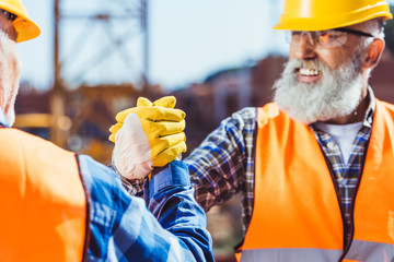 construction workers shaking hands