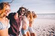 © Criene Images - Group of young adult friends walking on the beach together