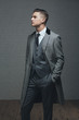 © Ania Boniecka/Stocksy - A handsome man in a three piece suit standing with hand in pocket