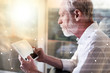 Senior businessman using a digital tablet, light effect, overlayed with network