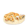 variety assortment of various  baked filled pastry on wicker rattan coaster isolated over white background