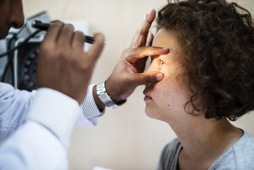 Wall Mural - Young Caucasian girl getting an eye examination