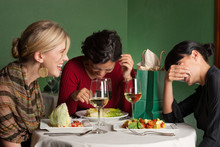 Three Women Laugh Heartily Over Lunch