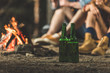 © LIGHTFIELD STUDIOS - bottles of beer next to bonfire