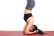 © Vittaya_25 - close up young asian woman doing yoga in Salamba Sirsasana or Supported Headstand yoga pose on the mat isolated on white background, exercise fitness, sport training, healthy lifestyle, people concept