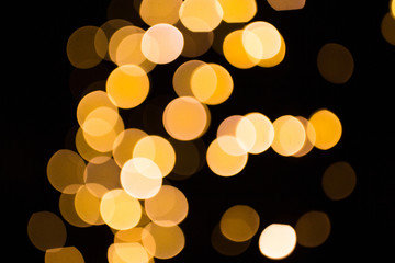 Wall Mural - blurred golden lights over dark background