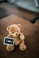 Wall Mural - bear doll and I love you plate on the wood table with dramatic tone