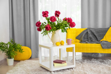 Poster - Interior of beautiful light modern room with peony flowers on table