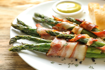 Sticker - Plate with bacon wrapped asparagus on table, closeup