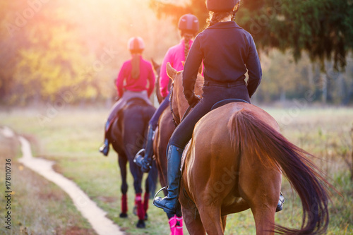 Fotografía Group of teenage girls riding horses in autumn park