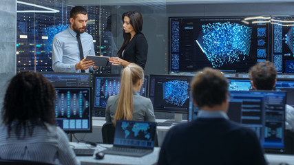 Fototapete - Head of the Department and Project Manager Discuss Work Process Using Data on Tablet Computer. Multi-Ethnic Team Builds Neural Network with Integrated Machine Learning.