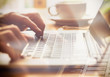 © Duncan Andison - A closeup of an office worker using a computer keyboard, laptop on a sunny morning, evening.