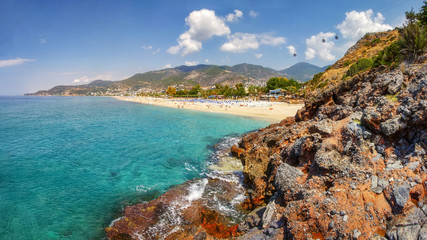 Wall Mural - Mountains and seascape on sunny summer day in Alanya, Turkey. Beautiful view on tropical beach and coastline through Turkish rocks.