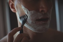 Man Shaving His Beard With Razor