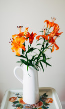 Pitcher Of Vibrant Orange Lilies On Vintage Metal Tray