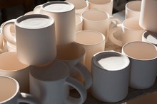 Ceramic mugs arranged on worktop