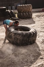 Young Woman Exercising With A Tractor Tyre