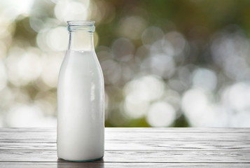 Wall Mural - Milk bottle on natural background