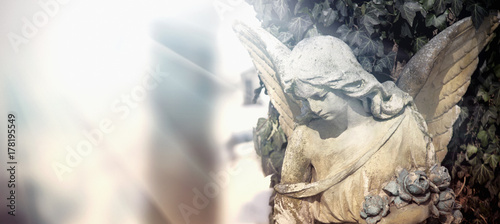 Cuadros en Lienzo Vintage image of a sad angel on a cemetery. Ancient statue.