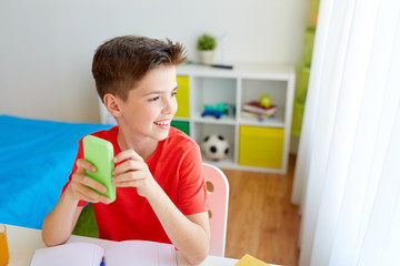 Canvas Print - student boy with smartphone distracting from study