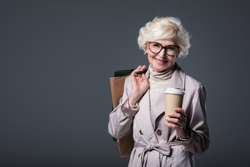 Wall Mural - senior woman with shopping bags and coffee