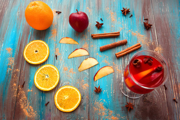 Wall Mural - Orange, apple, cinnamon, anise, wine (mulled wine) on wooden background