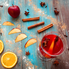 Wall Mural - Orange, apple, cinnamon, anise, wine (mulled wine) on wooden background