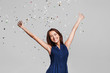 © kite_rin - Beautiful happy woman at celebration party with confetti falling everywhere on her. Birthday or New Year eve celebrating concept