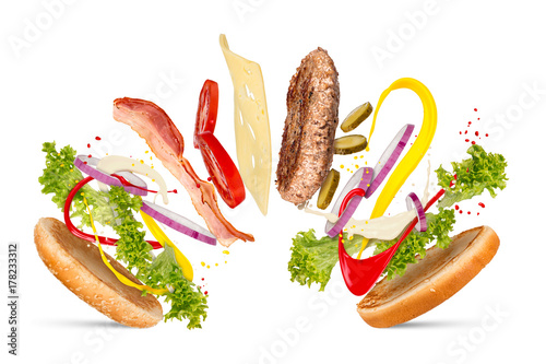 Fotografie, Obraz creativ explosion ingredients of a cheesburger hamburger falling down flying con
