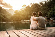 Couple in love and sunset over the lake