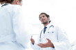 © ASDF - Two Doctors Having Meeting In Hospital Reception Area