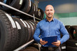 © Syda Productions - auto business owner and wheel tires at car service