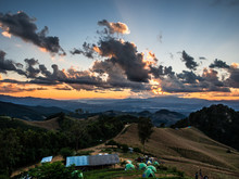 The Camping At The Top Of The Mountain At Doi Samer Dao, Nan, Thailand. The Landscape Moment Of Orange Sky Before Sunset Behind The Cloudy Sky And Hil. Such A Nice Place For Traveler To Visit