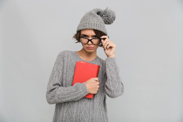 Poster - Serious concentrated woman holding book.