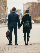 Couple Holding Hands On Crossroad