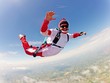 Red skydiver. Classic position free fall