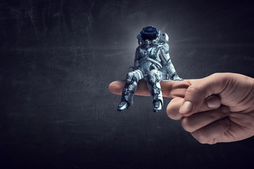 Wall Mural - spaceman on finger. mixed media