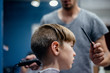 © Cara Slifka/Stocksy - Boy gets a funky haircut at a barber shop
