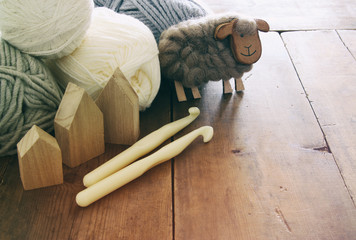 Wall Mural - warm and cozy yarn balls of wool on wooden table.