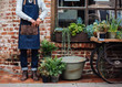 © Trinette Reed/Stocksy - Small artisan business owner standing in front of store