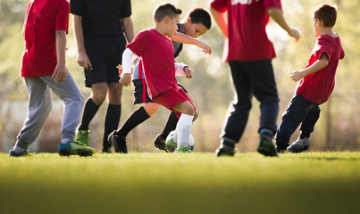 Wall Mural - Kids soccer football - children players match on soccer field