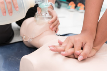  Nursing students are learning how to rescue the patient in emergency. CPR training with CPR doll. Closed-up. Soft focus.