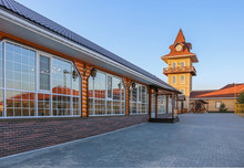 Cafe With A Glass Facade And A Clock Tower