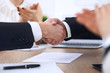 © rogerphoto - Close up of business people shaking hands at meeting or negotiation in the office. Partners are satisfied because signing contract