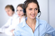 © rogerphoto - Call center. Focus on beautiful business  woman in headset