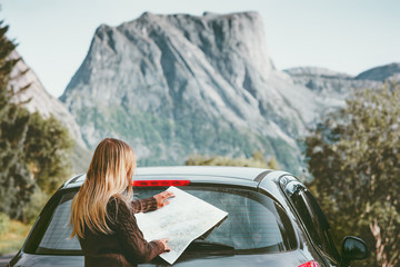 Woman traveling by car on road trip with map planning route Lifestyle concept adventure vacations outdoor