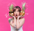 © LIGHTFIELD STUDIOS - young woman holding pineapples