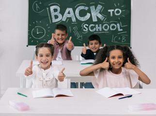 Wall Mural - multiethnic schoolkids with thumbs up