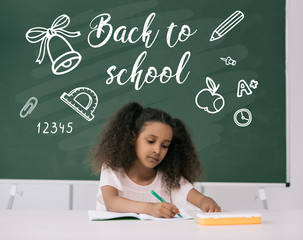 Wall Mural - African American schoolgirl studying